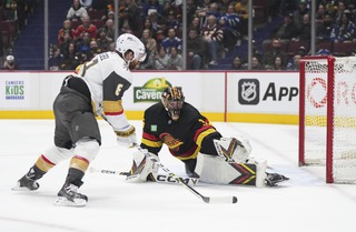 Vegas Golden Knights' Phil Kessel, left, scores against Vancouver Canucks goalie Thatcher Demko during the first period Tuesday, March 21, 2023, in Vancouver, British Columbia. 


