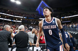 Gonzaga Bulldogs guard Julian Strawther (0) heads back to the court after celebrating with his father Lee and sisters following Gonzagas 79-76 victory over UCLA in a Sweet Sixteen NCAA Tournament basketball game at T-Mobile Arena Thursday, March 23, 2023.
