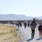Photo: Migrants walk along the Mexico-U.S. border in Ciud