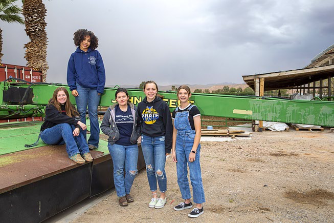 High School students pose on a piece of farm equipment at the Moapa Valley High School Laboratory Farm in Overton Thursday, March 30, 2023. From left: Emma Gollahon, Layla Moncrief, McKenna Melvin, Faith Kelly, and Emma Bowler.