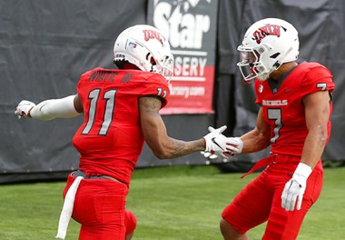 UNLV Rebels wide receiver Ricky White (11) is congratulated by wide receiver Jacob De Jesus (7) after making a touchdown catch during the UNLV Spring Showcase at Allegiant Stadium Saturday, April 8, 2023.