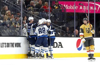 Winnipeg Jets celebrate a goal by right wing Blake Wheeler (26) as Vegas Golden Knights right wing Mark Stone (61) skates by during the third period of Game 1 of an NHL hockey Stanley Cup first-round playoff series at T-Mobile Arena Tuesday, April 18, 2023, in Las Vegas.