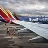 A Southwest Airlines ground crew directs a plane out of the terminal at Hollywood Burbank Airport in Burbank, Calif. on Feb. 14, 2023.