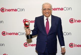 Director Martin Scorsese holds up his 