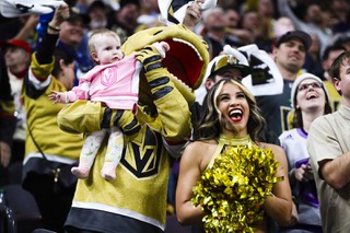 A young Vegas Golden Knights fan celebrates with Chance the Gila monster and a Vegas Golden Knights Vegas Vivas cheerleader during the second period of Game 5 in an NHL hockey Stanley Cup first-round playoff series against the Winnipeg Jets at T-Mobile Arena Thursday, Apr. 27, 2023.