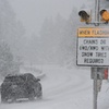 A car passes a caution sign as heavy snow falls on the Mt. Rose Highway near Reno, Nev., on Dec. 1, 2022. The federal government on Friday, April 28, 2023, has made Nevada state, tribal, and local entities eligible for financial assistance for costs of recovering from severe winter storms that affected rural parts of the state in March. 

