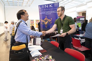 Navy vet Daniel Salvatierra shakes hands with Tom Hannett, director of Denver operations for Kink Technologies, during an EmployNV Business Hub Veterans Job and Resource Fair at the West Sahara Library Tuesday, May 2, 2023. The IT managed services and staffing company has operations in Las Vegas, Phoenix and Denver, Hannett said.