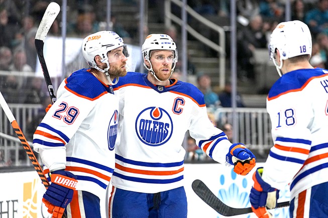 Edmonton Oilers teammates Connor McDavid, middle, Leon Draisaitl, left, and Zach Hyman celebrate a goal against the San Jose Sharks Jan. 13, 2023, in San Jose, Calif. Slowing McDavid and Draisaitl’s scoring prowess will be a major point of emphasis for the Vegas Golden Knights as they begin their second-round Stanley Cup Playoff series today, May 3, 2023.
