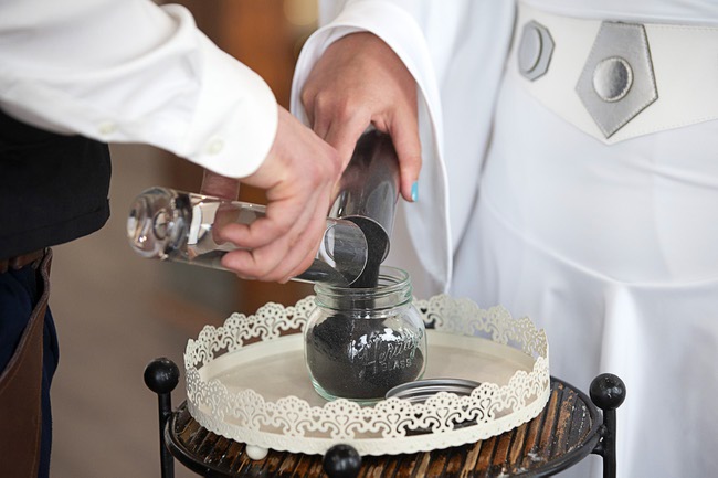 Evan Browning and Malia Matheson of Middlesex, Vt. mix vials of sand (reportedly from the planet Tattooine) during a wedding at the Little Vegas Chapel Thursday, May 4, 2023. Chapels were busy all day with Star Wars-themed weddings as fans came to get married on May the Fourth (May The Force).