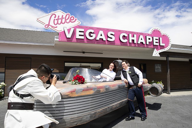 Malia Matheson and Evan Browning of Middlesex, Vt. pose by a Landspeeder replica after getting married at the Little Vegas Chapel Thursday, May 4, 2023. Elmer Turcios-Arriaza, dressed as a Jedi Knight, takes photos. Chapels were busy all day with Star Wars-themed weddings as fans came to get married on May the Fourth (May The Force).