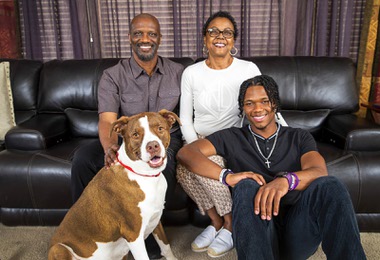 Former UNR football player JoJuan Claiborne poses with his father John, his mother Juan and Bun, a four-year-old pit bull-Great Dane mix, at their home in northwest Las Vegas Thursday, May 11, 2023. His mom was diagnosed with pancreatic cancer in 2021, so Claiborne transferred to UNLV for his final season to be close to her and help her through treatment. 