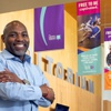 Kelvin Watson, executive director of the Las Vegas-Clark County Library District, poses under banners at the Windmill Library Tuesday, May 16, 2023. Las Vegas-Clark County Library District's new marketing campaign utilizes updated signage to advertise the Library resources.