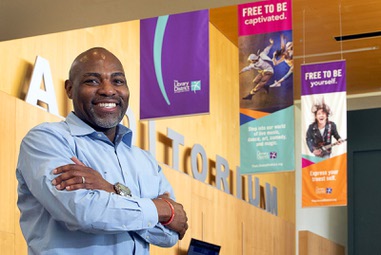 Kelvin Watson, executive director of the Las Vegas-Clark County Library District, poses under banners at the Windmill Library Tuesday, May 16, 2023. Las Vegas-Clark County Library District’s new marketing campaign utilizes updated signage to advertise the Library resources.