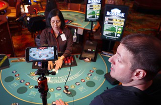 Influencer Victor Ross records video of his blackjack play for All Casino Action at the El Cortez in downtown Las Vegas Thursday, May 18, 2023. His videos can be viewed on YouTube and Facebook. Dealer Mu Mu Aund is at center.
