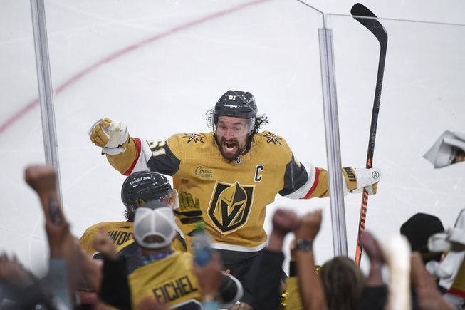 Vegas Golden Knights wing Mark Stone celebrates with Brett Howden, obscured at lower left, who scored in overtime against the Dallas Stars during Game 1 of the NHL hockey Stanley Cup Western Conference finals Friday, May 19, 2023, in Las Vegas. The Golden Knights won 4-3.