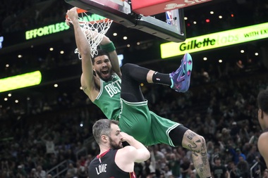 Boston Celtics forward Jayson Tatum, top, dunks as Miami Heat forward Kevin Love defends during the first half in Game 5 of an NBA basketball Eastern Conference Final series Thursday, May 25, 2023, in Boston.


