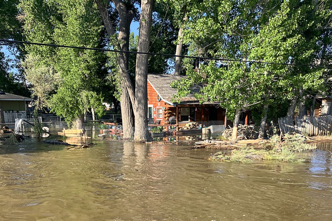 A home is encroached upon by floodwaters near the Mason Bridge in Mason, Nev. last month. The area could have been further inundated if not for the removal of a tree that was blocking the culverts under the bridge.  - Photo courtesy of Taylor Allison, emergency/communications manager for Lyon County office of Emergency Management
