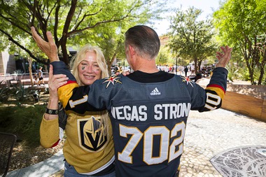 Lynne Portaro poses with her husband Ron Portaro as he shows off a custom Oct. 1 Vegas Golden Knights jersey in The Park before Game 1 of the Stanley Cup Final between the Golden Kinights and the Florida Panthers at T-Mobile Arena Saturday, June 3, 2023.