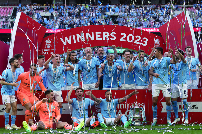 Manchester City players celebrate after winning the English FA Cup final soccer match between Manchester City and Manchester United at Wembley Stadium in London, Saturday, June 3, 2023.