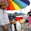 Photo: Street vendor Luis Sanchez waits for customers by 