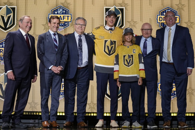 David Edstrom, center, poses with Las Vegas Golden Knights officials after being picked by the team during the first round of the NHL hockey draft Wednesday, June 28, 2023, in Nashville, Tenn. 

