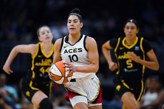 Las Vegas Aces guard Kelsey Plum (10) brings the ball up during the first half of the team's WNBA basketball game against the Los Angeles Sparks on Wednesday, July 12, 2023, in Los Angeles. (AP Photo/Ryan Sun)