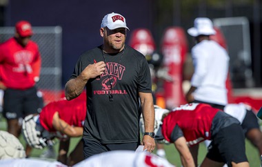 UNLV football head coach Barry Odom watches as players warm up during UNLV football training camp at Rebel Park Friday, Aug. 4, 2023.