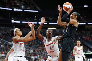 Las Vegas Aces forward A'ja Wilson (22) tskes a shot in front of Phoenix Mercury forwards Brianna Turner (21) and Michaela Onyenwere (12) during the second half of a WNBA basketball game at T-Mobile Arena Sunday, Sept. 10, 2023.
