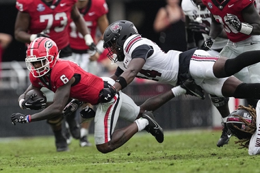 Georgia wide receiver Dominic Lovett (6) is stopped by South Carolina defensive back Jalon Kilgore (24) during the first half of an NCAA college football game Saturday, Sept. 16, 2023.