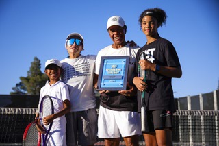 Members of No Quit Tennis Academy, from left, Xander Tuzon, 10, coach Claudia, coach James Johnson and  Addison Alele, 12, pose for a photo with the 2023 Outstanding Tennis Facility Award from the United States Tennis Association at Lorenzi Park Monday, Sept. 18, 2023.