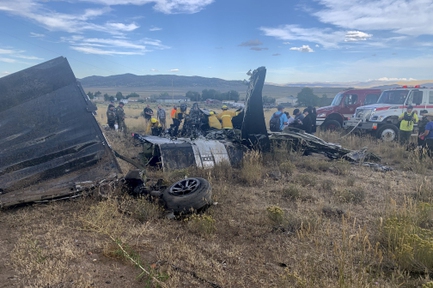 Members of the Truckee Meadows Fire and Rescue Department of California and other officials look over aircraft wreckage, Sunday, Sept. 17, 2023, in Reno, after two California pilots were killed when their planes collided in mid-air while preparing to land after completing a race at the National Championship Air Races north of Reno.
