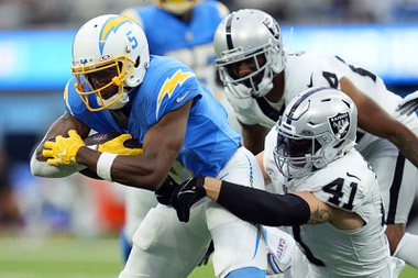 Los Angeles Chargers wide receiver Joshua Palmer (5) is tackled by Las Vegas Raiders linebacker Robert Spillane (41) during the first half of an NFL football game Sunday, Oct. 1, 2023, in Inglewood, Calif. (AP Photo/Ashley Landis)