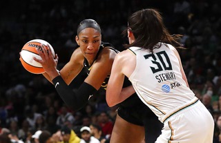 Las Vegas Aces forward A'ja Wilson (22) is guarded by New York Liberty forward Breanna Stewart (30) during the second half of Game 1 in a WNBA basketball final playoff series at Michelob Ultra Arena Sunday, Oct. 8, 2023.