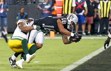 Las Vegas Raiders wide receiver Jakobi Meyers (16) gets past Green Bay Packers safety Rudy Ford (20) to score a touchdown during the first half of an NFL game at Allegiant Stadium Monday, Oct. 9, 2023.