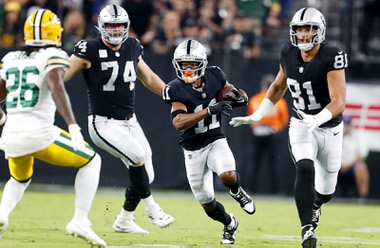 Las Vegas Raiders wide receiver Tre Tucker (11) carries the ball against the Green Bay Packers during the first half of an NFL game at Allegiant Stadium Monday, Oct. 9, 2023. With turner are Las Vegas Raiders offensive tackle Kolton Miller (74) and tight end Austin Hooper (81)