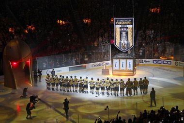 Vegas Golden Knights players watch the raising of a 2023 Stanley Cup championship banner before an NHL hockey game between the Golden Knights and the Seattle Kraken at T-Mobile Arena Tuesday, Oct. 10, 2023.