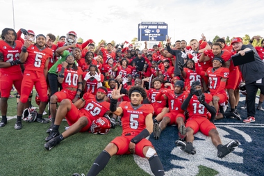 The UNLV football team celebrates its victory against UNR in the Fremont Cannon rivalry game on Oct. 14, 2023, at Mackay Stadium in Reno. 