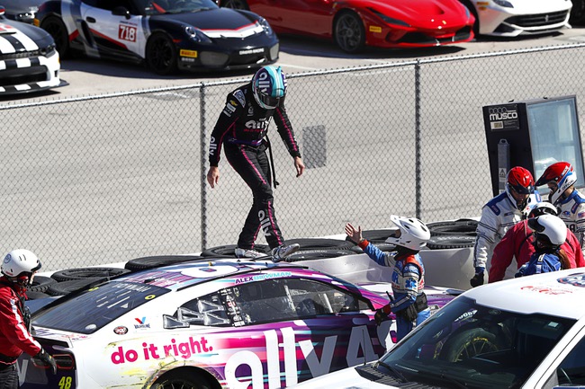 Alex Bowman (48) walks across the roof of his car after hitting the frontstretch wall and the tire barrier on the inside of turn one during the South Point 400 NASCAR Cup Series auto race at the Las Vegas Motor Speedway Sunday, Oct. 15, 2023.