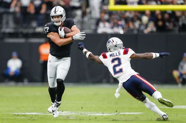 Las Vegas Raiders tight end Michael Mayer (87) runs the ball as New England Patriots cornerback Jalen Mills (2) attempts a tackle during the first half of a NFL football game at Allegiant Stadium Sunday, Oct. 15, 2023.