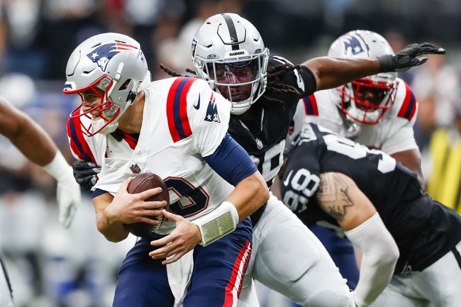 Las Vegas Raiders defensive tackle Adam Butler (69) moves to tackle New England Patriots quarterback Mac Jones (10) during the first half of a NFL football game at Allegiant Stadium Sunday, Oct. 15, 2023.