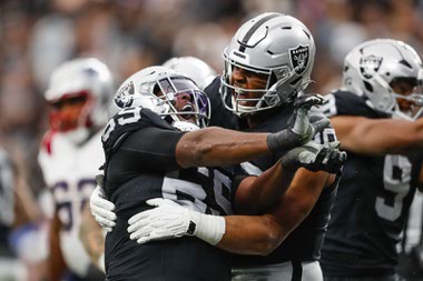 Las Vegas Raiders defensive tackle Adam Butler (69) and Las Vegas Raiders defensive tackle Jerry Tillery (90) celebrate after Butler sacks New England Patriots quarterback Mac Jones (10) during the first half of a NFL football game at Allegiant Stadium Sunday, Oct. 15, 2023.