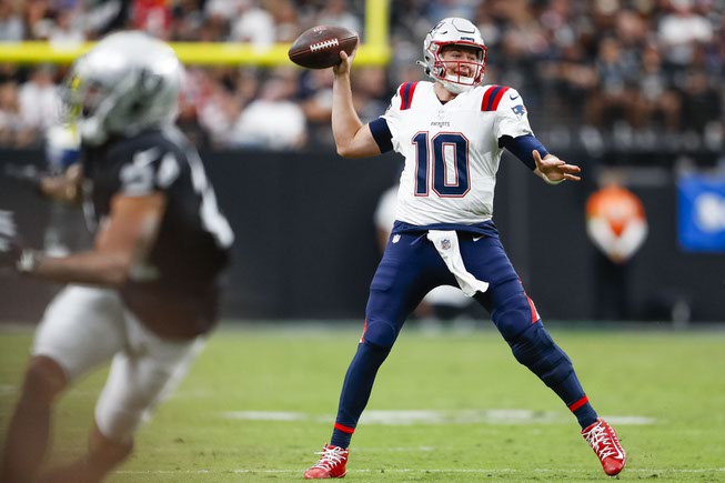 New England Patriots quarterback Mac Jones (10) looks to pass the ball during the first half of a NFL football game against the Las Vegas Raiders at Allegiant Stadium Sunday, Oct. 15, 2023.