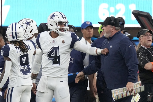 Dallas Cowboys quarterback Dak Prescott (4) talks with Cowboys head coach Mike McCarthy, right, during the first half of an NFL football game against the Los Angeles Chargers, Monday, Oct. 16, 2023, in Inglewood, Calif. 


