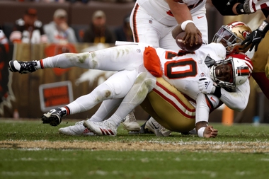 Cleveland Browns quarterback PJ Walker (10) is sacked by San Francisco 49ers linebacker Randy Gregory (5) during an NFL football game, Sunday, Oct. 15, 2023, in Cleveland.