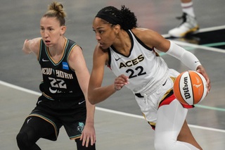 Las Vegas Aces' A'ja Wilson, right, drives past New York Liberty's Courtney Vandersloot during the first half in Game 4 of a WNBA basketball Finals playoff series Wednesday, Oct. 18, 2023, in New York. 


