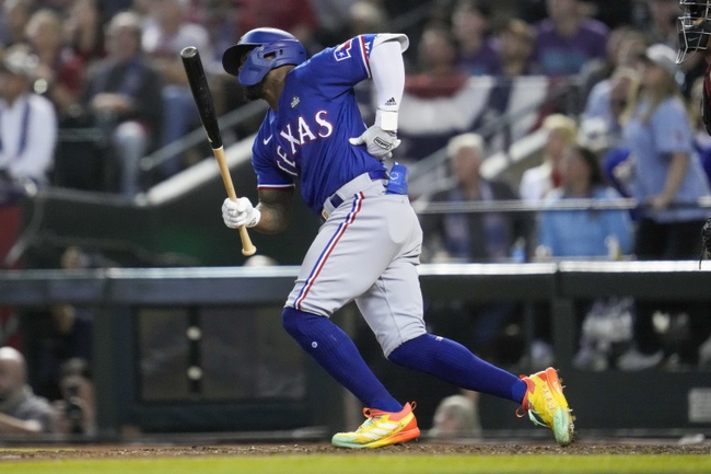 Texas Rangers' Adolis Garcia grabs his left side after his swing during the eighth inning in Game 3 of the baseball World Series against the Arizona Diamondbacks Monday, Oct. 30, 2023, in Phoenix. 


