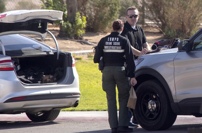 Officials confer near the entrance to athletic fields after a body was found at Hollywood Regional Park near Harney Middle School Tuesday, Nov. 7, 2023.
