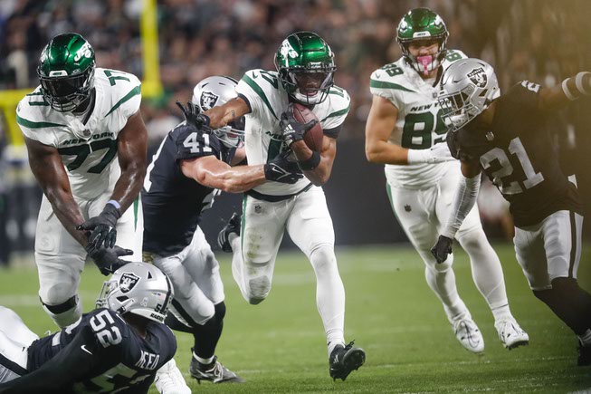 New York Jets wide receiver Garrett Wilson (17) runs the ball as Las Vegas Raiders linebacker Robert Spillane (41) tries to tackle him during the first half of an NFL football game at Allegiant Stadium Sunday, Nov. 12, 2023.