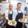 Executive chef Miguel Magana, left, and assistant chef Rolando Uclaray display Thanksgiving dinners, turkey left, and ham, at Vics Las Vegas, a restaurant and bar in Symphony Park near downtown, Wednesday, Nov. 15, 2023.