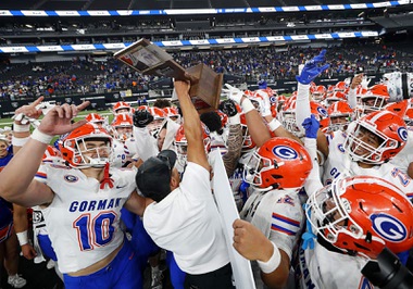 Bishop Gorman head coach Brent Browner celebrates with players after Bishop Gorman defeated Liberty 56-11 to win the Class 5A Division I state championship at Allegiant Stadium Tuesday, Nov. 21, 2023.